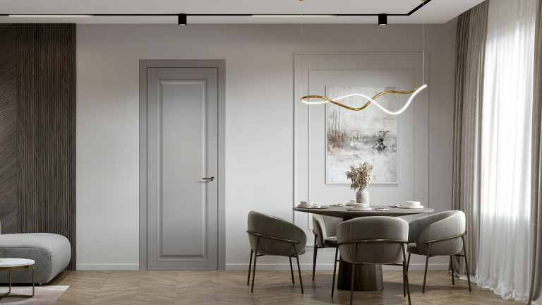 Серая дверь в стильной столовой с круглым столом и подвесным светильником.